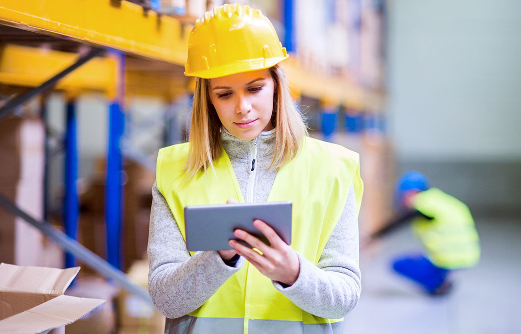 A female warehouse worker using an Android-powered tablet.