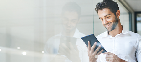 Man using a tablet that is managed and secured by SOTI MobiControl