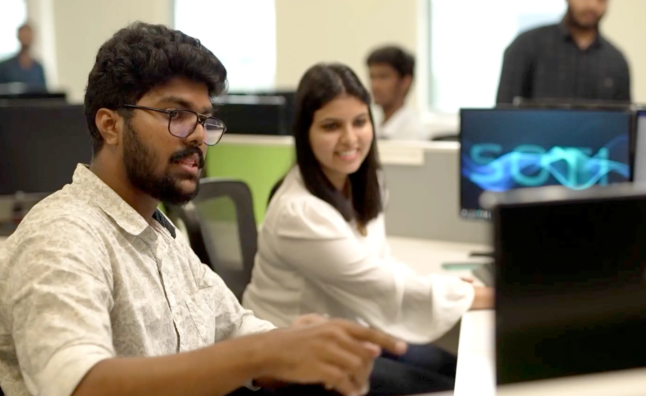 Image of employees on the computer